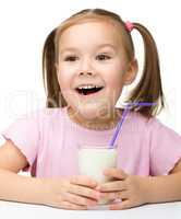 Cute little girl with a glass of milk