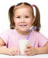 Cute little girl with a glass of milk