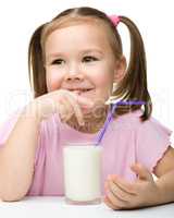 Cute little girl with a glass of milk