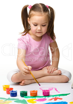 Cute cheerful child play with paints