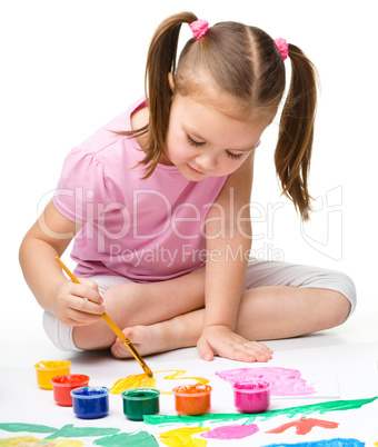 Cute cheerful child play with paints