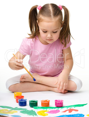 Cute cheerful child play with paints