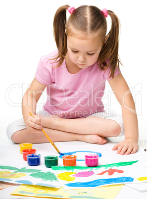 Cute cheerful child play with paints