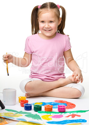 Cute cheerful child play with paints