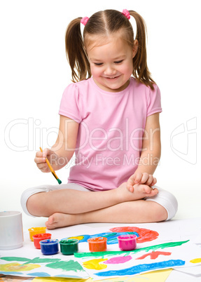 Cute cheerful child play with paints