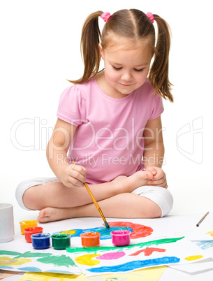 Cute cheerful child play with paints