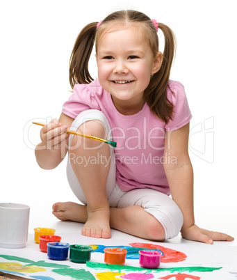 Cute cheerful child play with paints