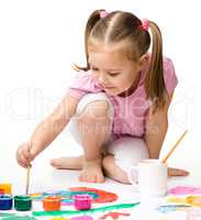 Cute cheerful child play with paints