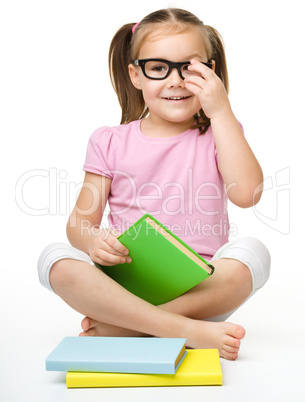 Cute little girl with books