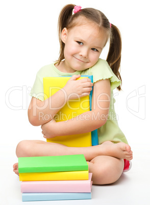 Cute little girl with books