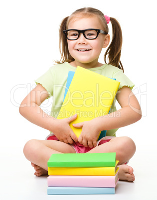 Cute little girl with books