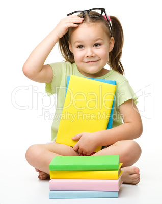 Cute little girl with books