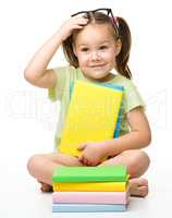 Cute little girl with books