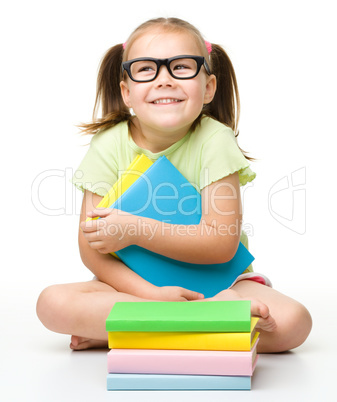 Cute little girl with books