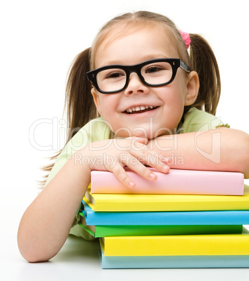 Cute little girl with books