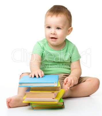 Portrait of a cute little boy with books