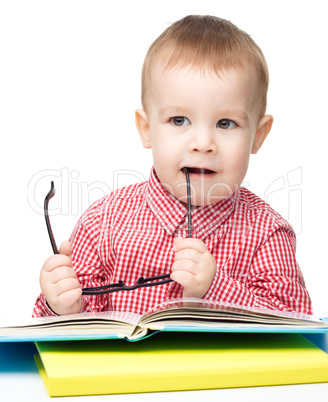 Little child play with book