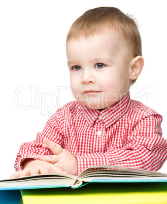 Little child play with book