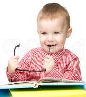 Cute little child play with book