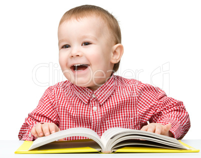 Little child play with book