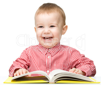 Cute little child play with book