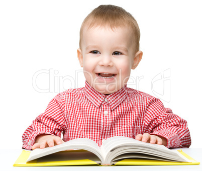 Little child play with book