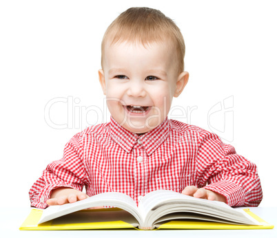 Little child play with book