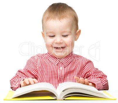 Little child play with book