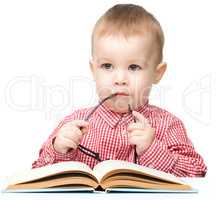 Cute little child play with book