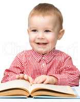 Little child play with book