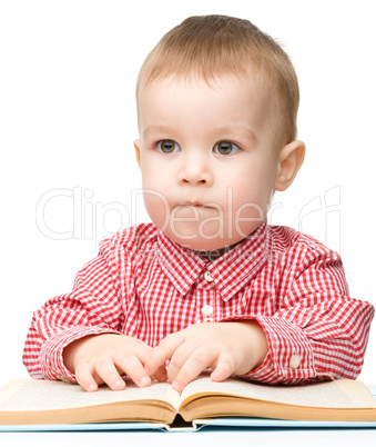 Cute little child play with book