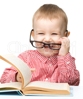 Cute little child play with book