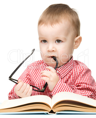 Cute little child play with book