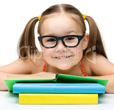 Cute little girl with books