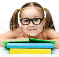 Cute little girl with books