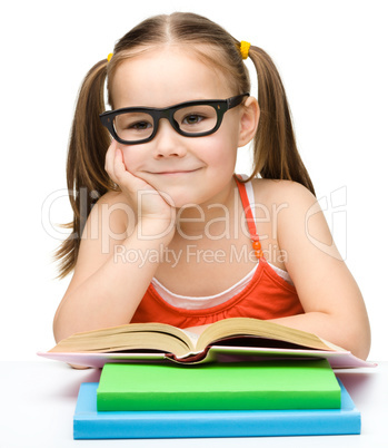 Cute little girl with books