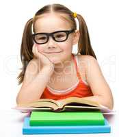 Cute little girl with books