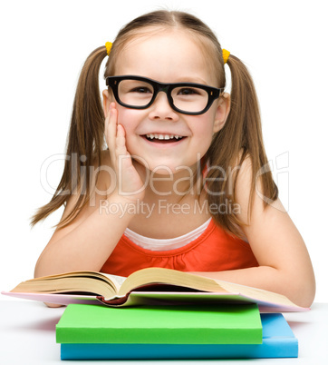 Cute little girl with books