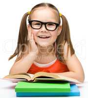 Cute little girl with books