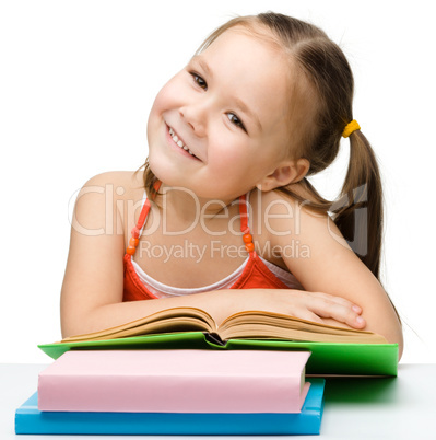 Cute little girl with books