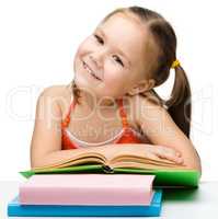 Cute little girl with books