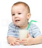 Cute little boy with a glass of milk