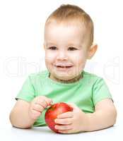 Portrait of a cute little boy with yellow apples