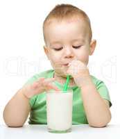 Cute little boy with a glass of milk