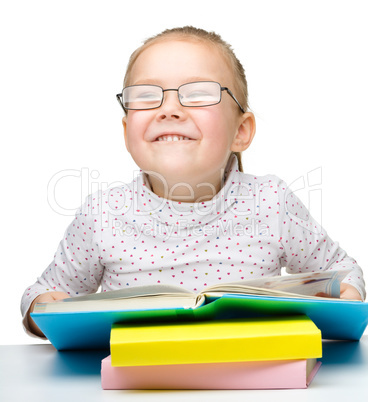 Cute little girl reading book