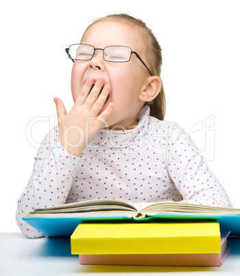 Cute little girl reading book