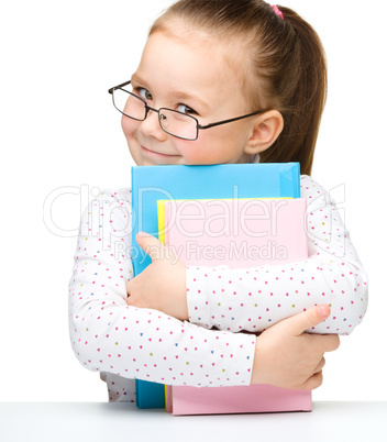 Cute little girl with books