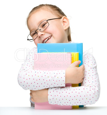 Cute little girl with books