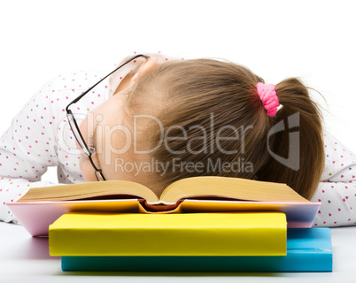 Little girl is sleeping on her books