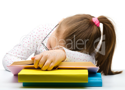 Cute little girl is sleeping on a book